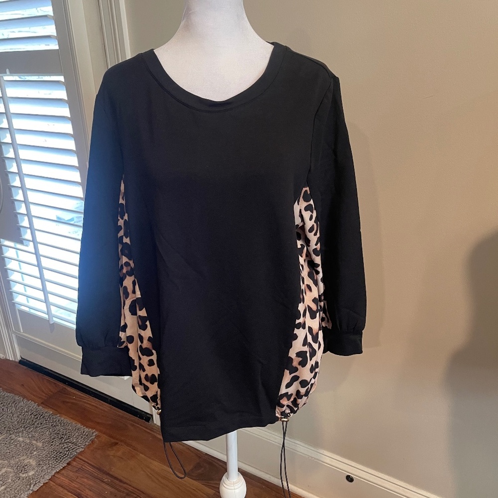 Pretty & sporty Chico's size 2 top black & leopard print. New with tags.